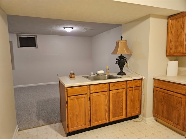 kitchen with sink, kitchen peninsula, and a textured ceiling