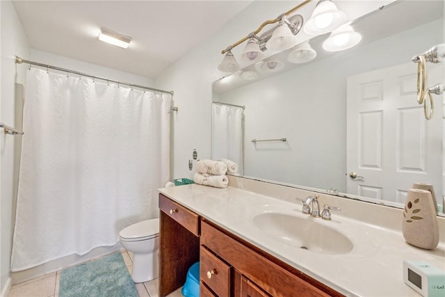 bathroom with tile patterned flooring, vanity, and toilet