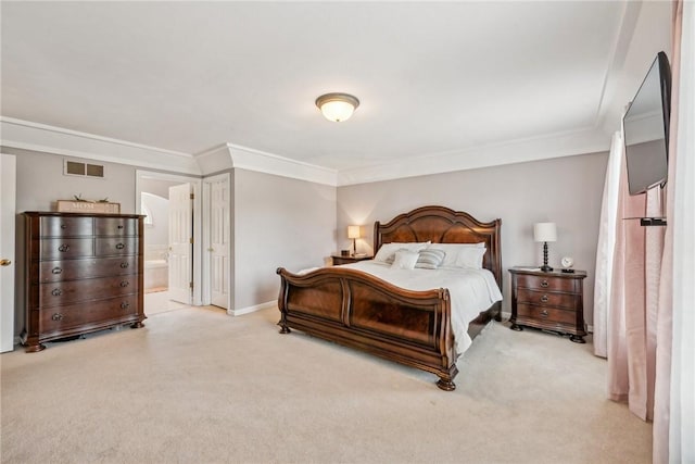 carpeted bedroom with connected bathroom and crown molding