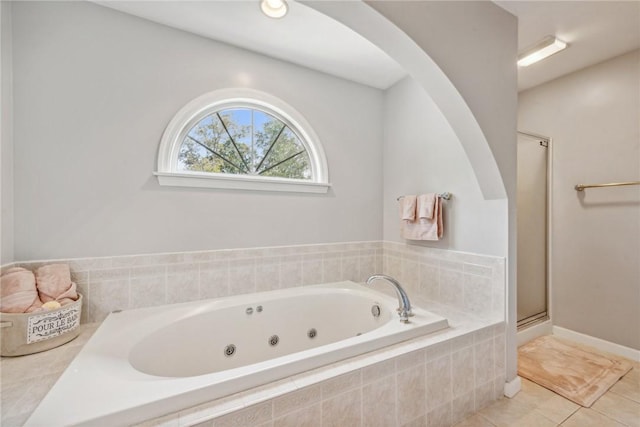 bathroom with tile patterned floors and shower with separate bathtub