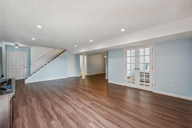 unfurnished living room with hardwood / wood-style flooring and french doors