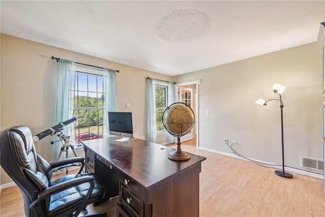 office space with light wood-type flooring