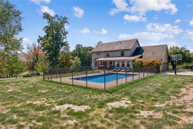 view of pool with a lawn and a patio