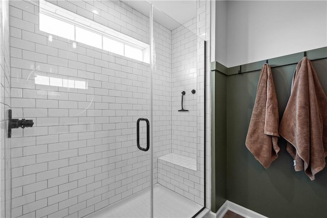 bathroom featuring a shower with door