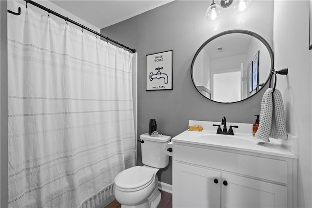 bathroom featuring vanity and toilet