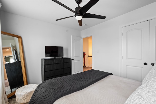 bedroom with ceiling fan and a closet