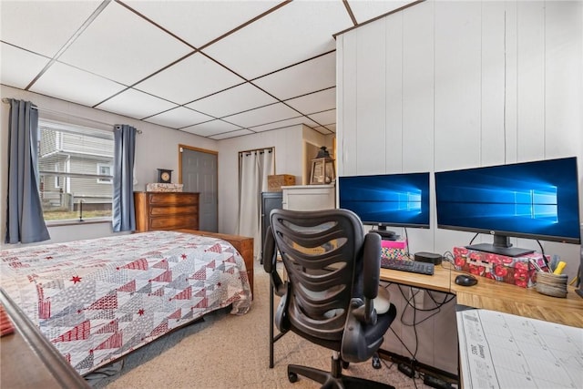 carpeted bedroom with a paneled ceiling