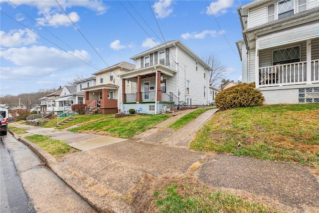 view of front of property with a porch and a front yard