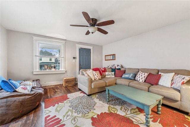 living room featuring dark hardwood / wood-style floors and ceiling fan