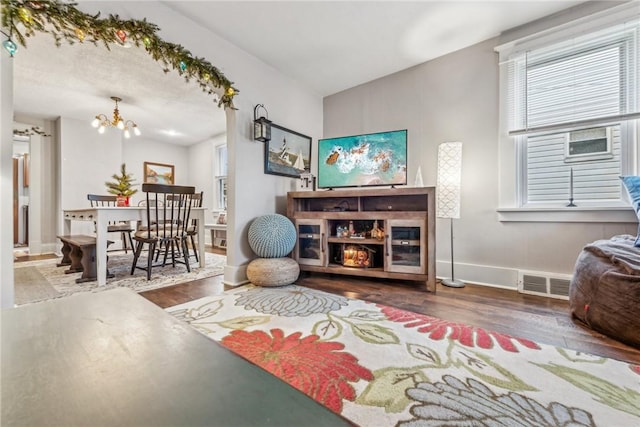 sitting room featuring wood-type flooring and a chandelier