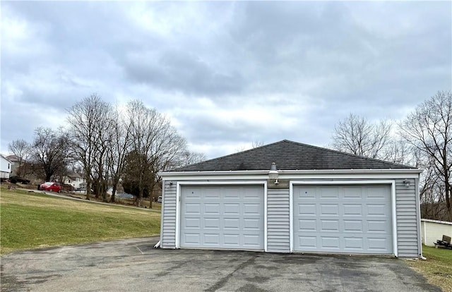 garage featuring a lawn