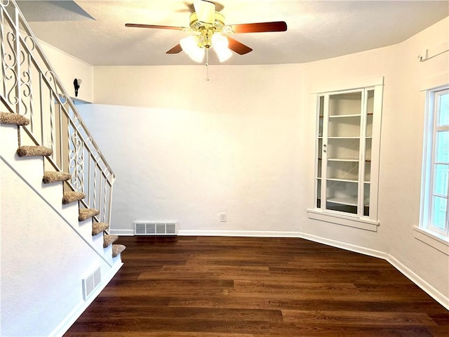 spare room with dark hardwood / wood-style floors and ceiling fan