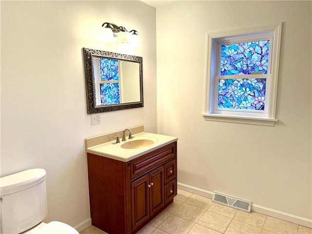 bathroom featuring tile patterned floors, vanity, and toilet