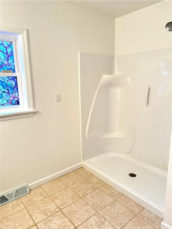 bathroom featuring tile patterned floors and walk in shower