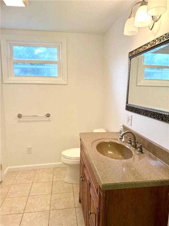 bathroom featuring tile patterned flooring, vanity, plenty of natural light, and toilet