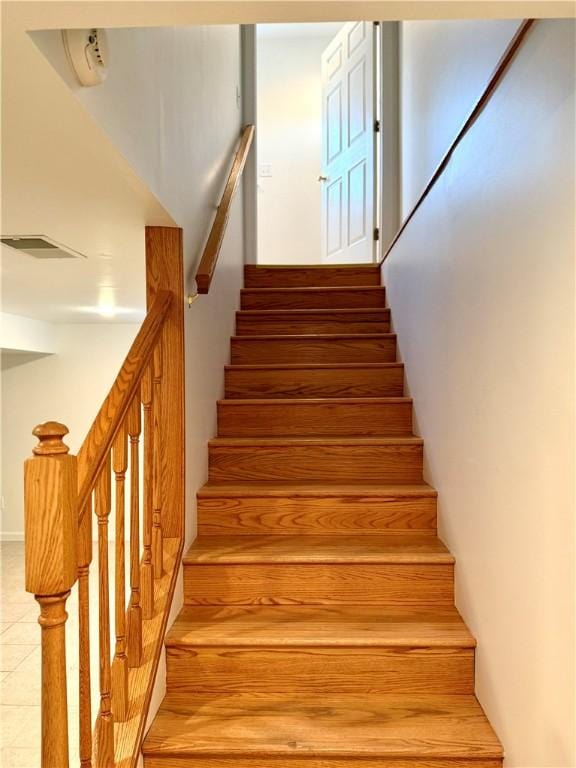 staircase with tile patterned floors