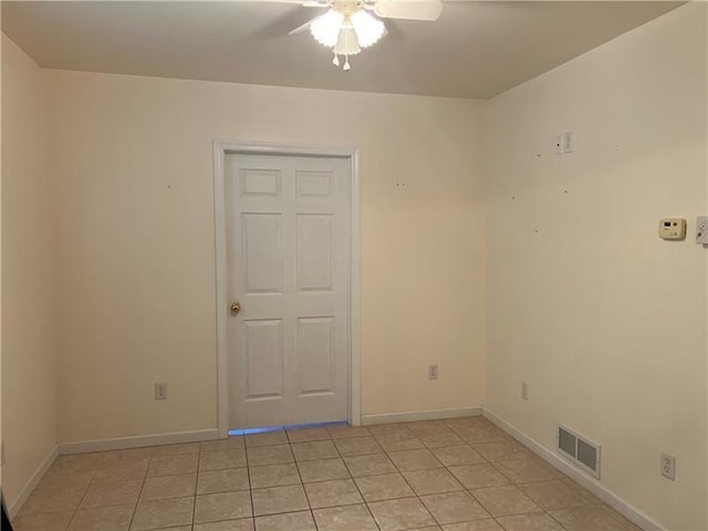 unfurnished room featuring ceiling fan and light tile patterned floors