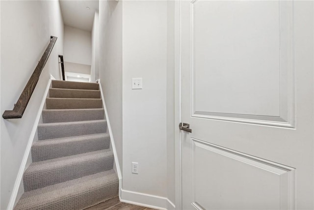 stairs featuring wood-type flooring