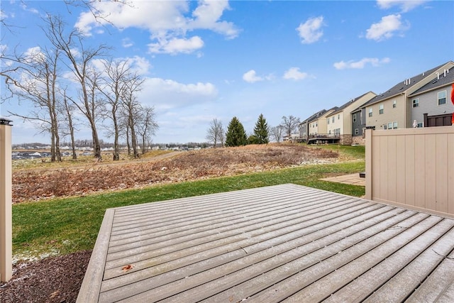 wooden terrace featuring a yard