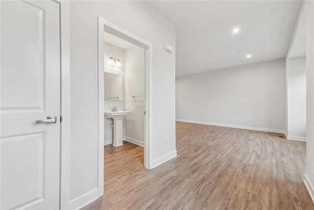 hallway featuring light hardwood / wood-style floors and sink