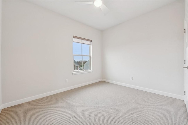 empty room featuring carpet floors and ceiling fan