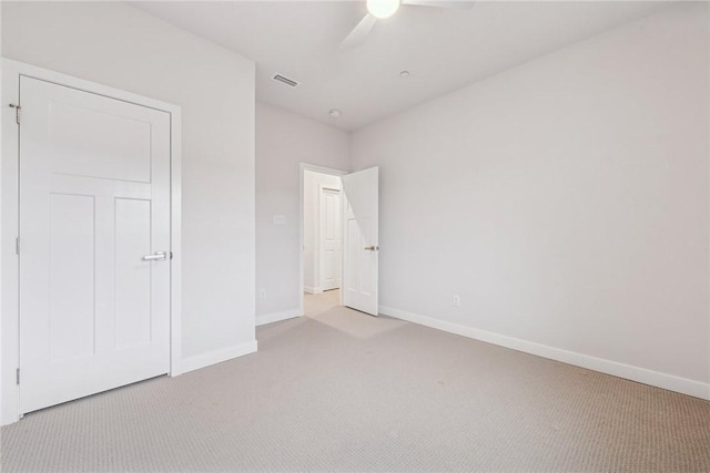 unfurnished bedroom with ceiling fan and light colored carpet