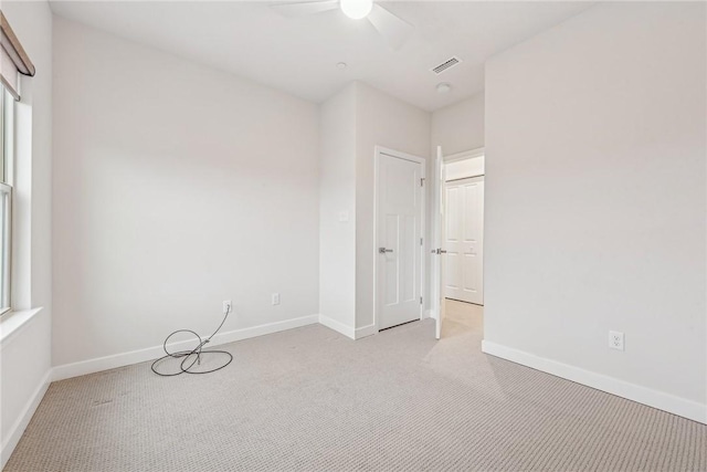 carpeted empty room featuring ceiling fan