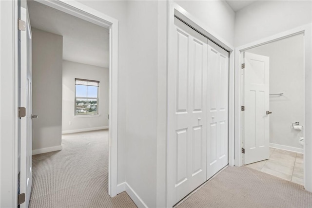 hallway with light colored carpet