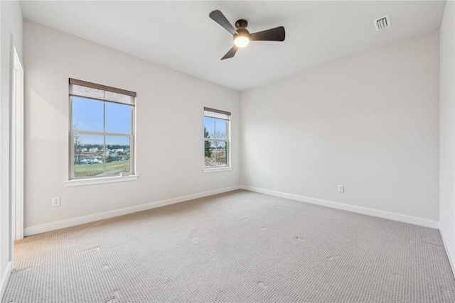 carpeted spare room with ceiling fan