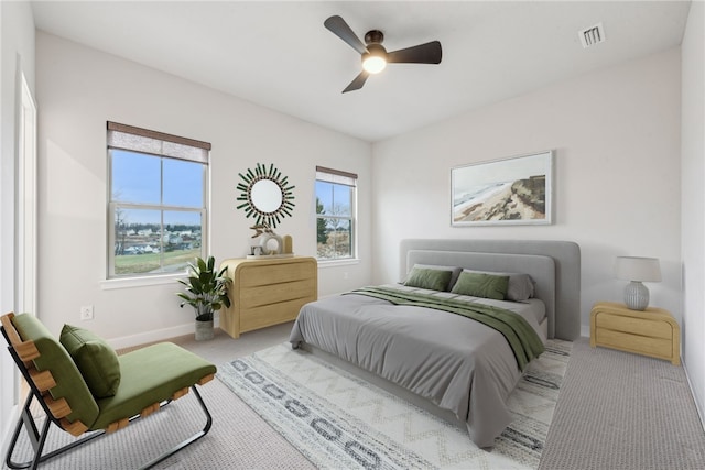 bedroom with light colored carpet and ceiling fan