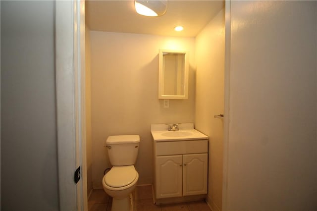 bathroom featuring tile patterned flooring, vanity, and toilet