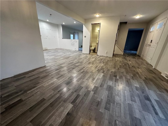 unfurnished living room with dark hardwood / wood-style floors