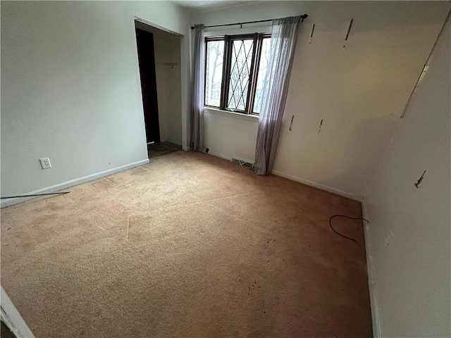 empty room featuring light carpet