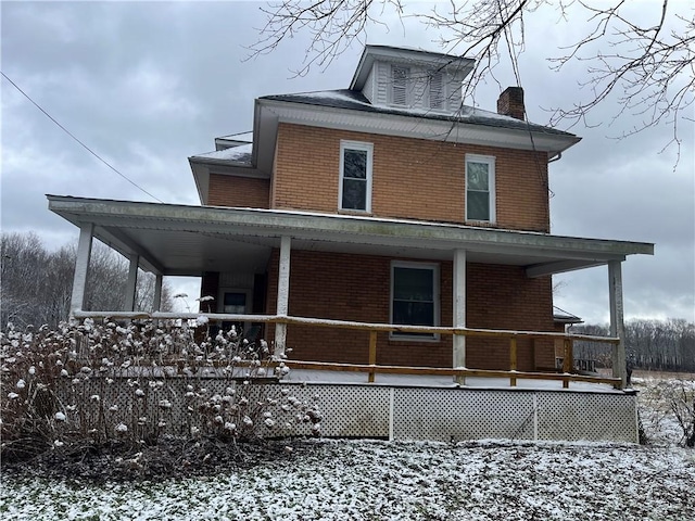 snow covered house with a porch