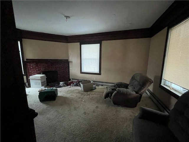 carpeted home theater room with a wealth of natural light, crown molding, a baseboard radiator, and a brick fireplace