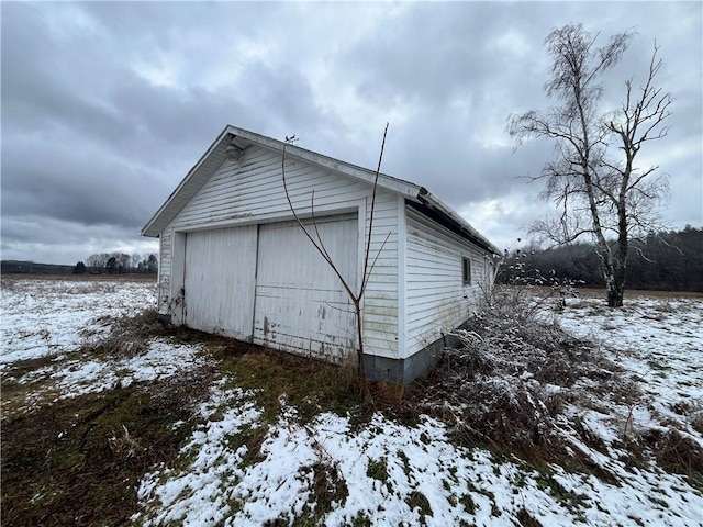 view of snowy exterior featuring an outdoor structure