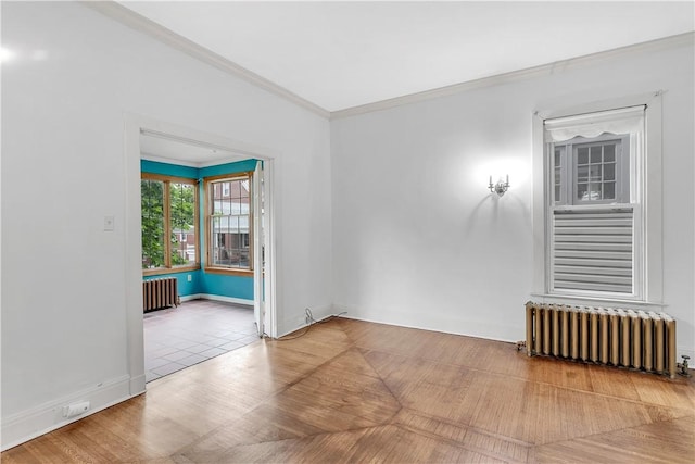 spare room with radiator, parquet flooring, and ornamental molding