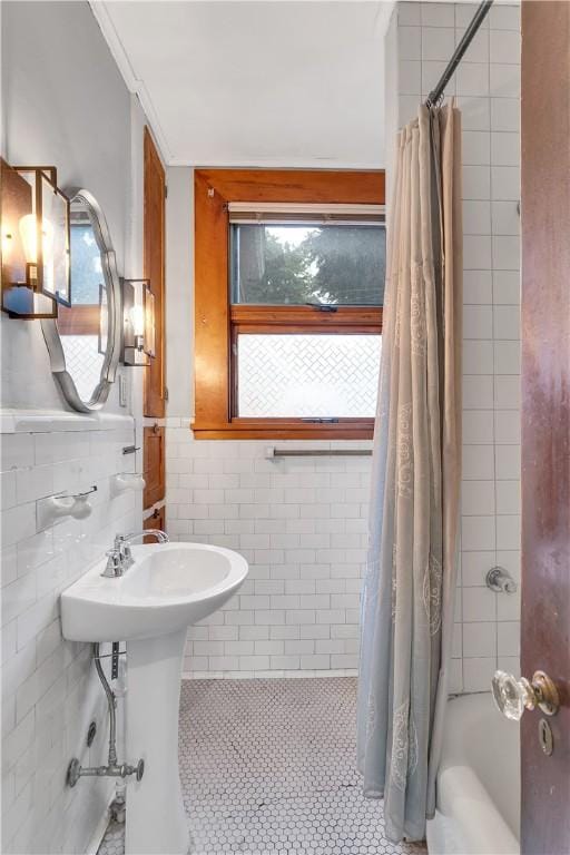 bathroom featuring tile patterned floors, tile walls, and shower / tub combo with curtain