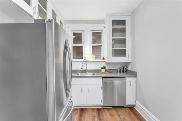 kitchen featuring white cabinets, appliances with stainless steel finishes, and sink