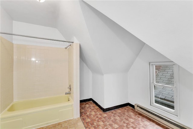 additional living space featuring baseboard heating and lofted ceiling