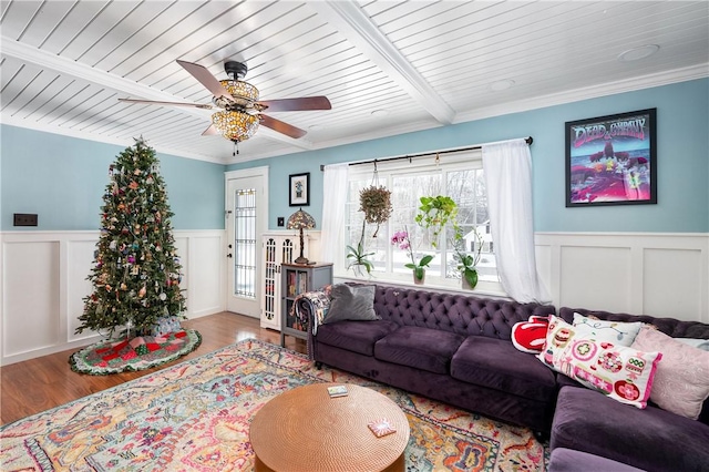 living room featuring hardwood / wood-style floors, ceiling fan, and ornamental molding