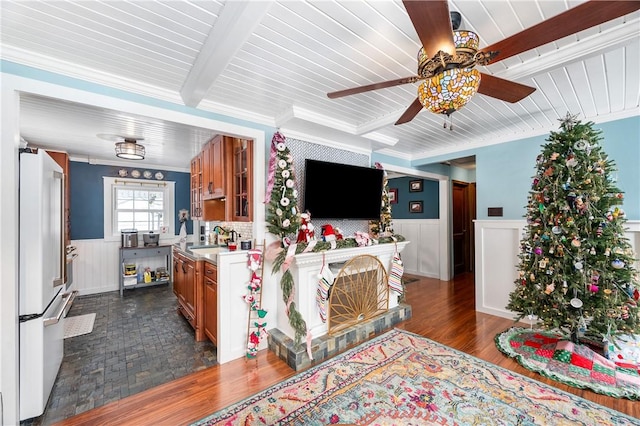 living room with dark wood-type flooring, sink, crown molding, ceiling fan, and beam ceiling