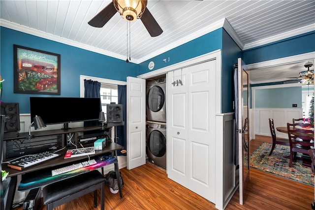 office space featuring wood-type flooring, crown molding, ceiling fan, and stacked washer / drying machine