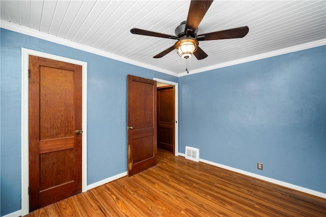 unfurnished bedroom with ceiling fan, ornamental molding, and hardwood / wood-style flooring