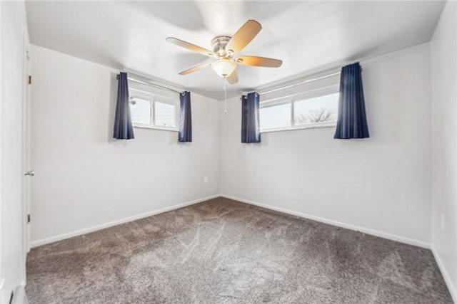 carpeted spare room featuring ceiling fan