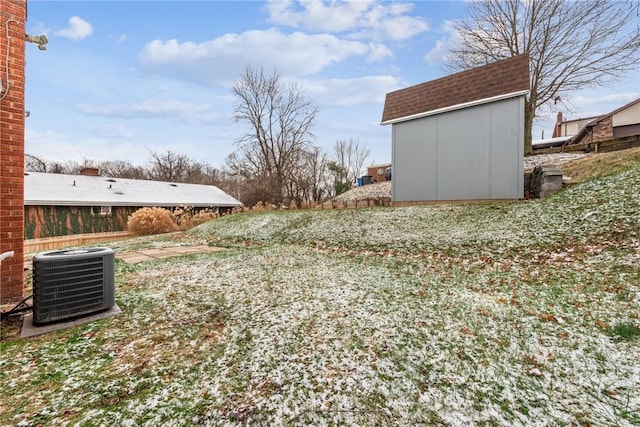 view of yard with a storage shed and central air condition unit