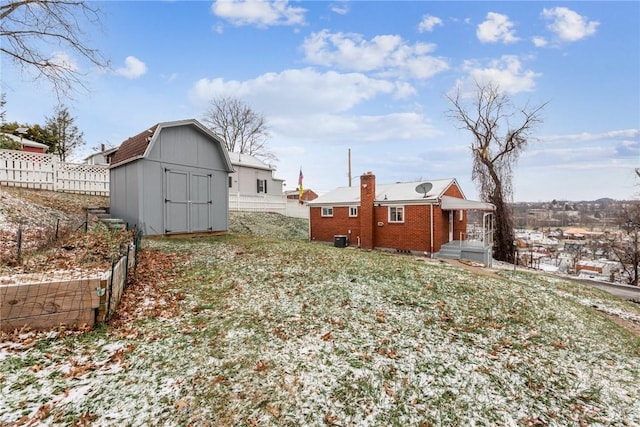 view of yard featuring central AC and a shed