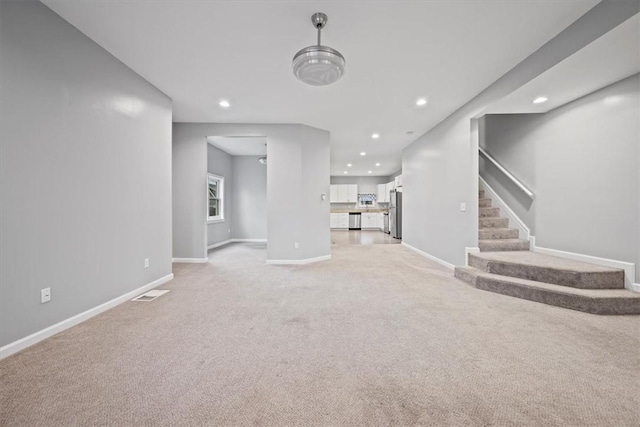 unfurnished living room featuring light colored carpet