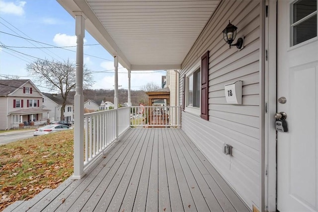 wooden terrace featuring covered porch