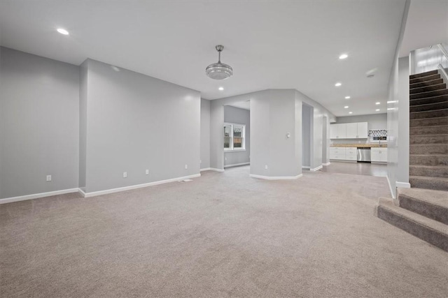 unfurnished living room featuring light colored carpet